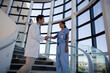 © KOTO - Doctor and nurse handshaking on hospital staircase