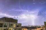 Fototapeta Tęcza - Toronto, Canada - August 30, 2021 : A massive lightning storm with large bolts over the Toronto skyline