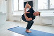 © Viacheslav Yakobchuk - Handsome Caucasian yoga instructor demonstrating various yoga positions in studio