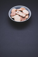 Poster - Vertical shot of biscuits on a black background