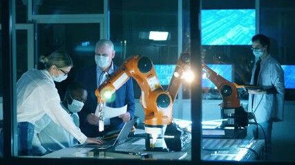 Wall Mural - robotics engineers are wearing face masks in the it laboratory