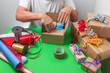 © Alex - Beautiful view of man packing Christmas gifts. Christmas holiday concept.  Postcard. Sweden.