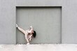 © ADDICTIVE STOCK - Graceful dancer performing near wall in city street
