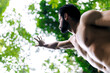 © ADDICTIVE STOCK - Shirtless man standing in forest in summer
