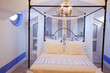 Chandelier over four poster bed in luxury bedroom
