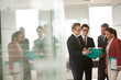 © KOTO - Business people talking in office lobby