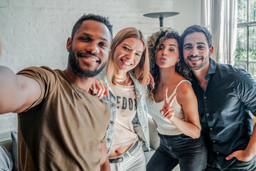 Wall Mural - Group of friends taking a selfie with a mobile phone.