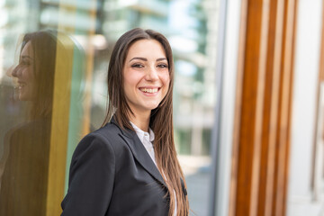 Wall Mural - Smiling businesswoman in a city