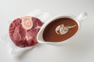 Raw meat and sauce bowl placed on white table