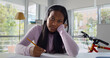 © nimito - Afro-american female teen student in headphones study online at home