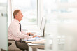© KOTO - Businessman sitting at desk in office
