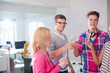 © KOTO - Business people cheering together in office
