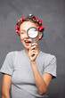 © Leart - Curious woman looking through a magnifying glass