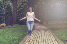 Young Happy Woman Jumping Rope With Pleasure Remembering Youth