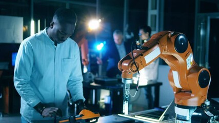 Wall Mural - laboratory robot is being operated by an african-american engineer