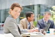 © KOTO - Businesswoman smiling in meeting outdoors