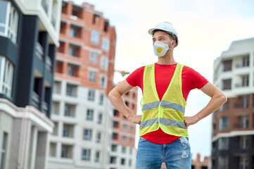 Poster - Male builder with hands on his hips looking away