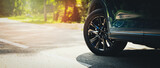 Fototapeta  - sport car with black alloy wheels on asphalt road. copy space