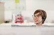 © KOTO - Businesswoman talking on headset at desk