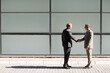 © KOTO - Businessmen shaking hands outdoors
