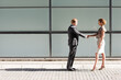 © KOTO - Business people shaking hands outdoors