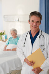 Wall Mural - Portrait of smiling doctor with patient in background