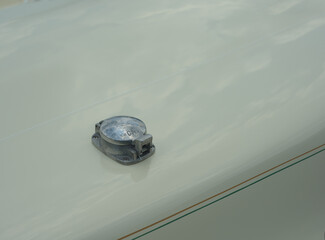 Wall Mural - Chrome metal gas spring-loaded gas cap on an old american classic automobile