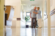© KOTO - Older patient and nurse standing in hospital
