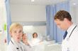 © KOTO - Doctor and nurse smiling in hospital room