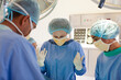 © KOTO - Surgeons bent over patient on operating table