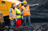 Fototapeta Przeznaczenie - Three workers in quarry with heavy machinery discussing