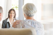 © KOTO - Financial advisor talking to couple on sofa