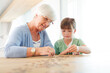 © KOTO - Older woman and granddaughter counting pennies