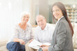 © KOTO - Financial advisor smiling with couple on sofa