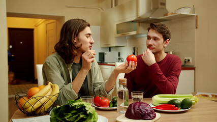 Two men are talking about vegetables and smiling