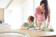 © KOTO - Mother helping daughter with homework
