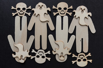 Wall Mural - wooden silhouettes with laser cut-scary monster masks and skull and bones on a dark background