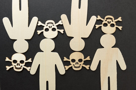 wooden silhouettes with laser cut-scary monster masks and skull and bones on a dark background