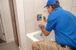 © spatesphoto - Plumber taking apart bathtub fixture