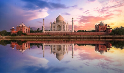 Fototapete - Taj Mahal sunset view from Mehtab Bagh on the banks of Yamuna river. Taj Mahal is a white marble mausoleum designated as a UNESCO World heritage site at Agra, India.