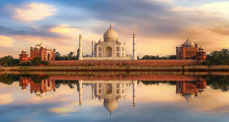 Fototapete - Taj Mahal Agra India at sunset with moody sky and water reflections on river Yamuna.	