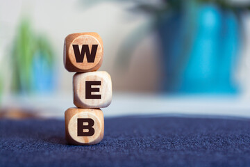 Wall Mural - WEB concept text on wooden cubes on a blur background