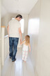 © KOTO - Father and daughter walking in corridor