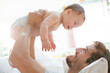 © KOTO - Father playing with baby son on sofa