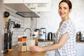 Woman professional space organizer smiling posing with case boxes for comfortable product storage