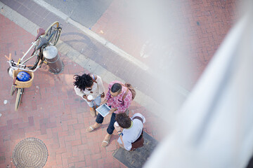 Wall Mural - Friends using digital tablet on city street