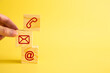 © chee siong teh - Businessman hand putting wooden block cube symbol telephone, email, address.