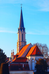 Wall Mural - Pfarre Maria Hietzing , catholic church in Vienna Austria . Old Church with tiled roof , spire with cross
