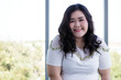© Bangkok Click Studio - Portrait closeup shot of Asian young happy confidence smart beautiful long black natural hair overweight fat female model sit relax smiling look at camera in front blurred glass windows background