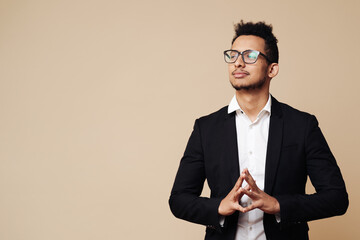Successful project. Business presentation. Portrait of confident proud Afro male CEO wearing glasses making presentation gestures with hands over beige background with copy space